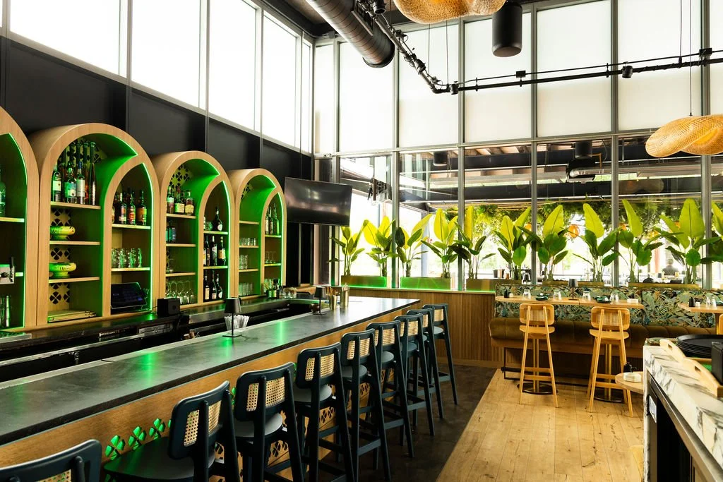 A long bar, with the arched shelving running the length of it.