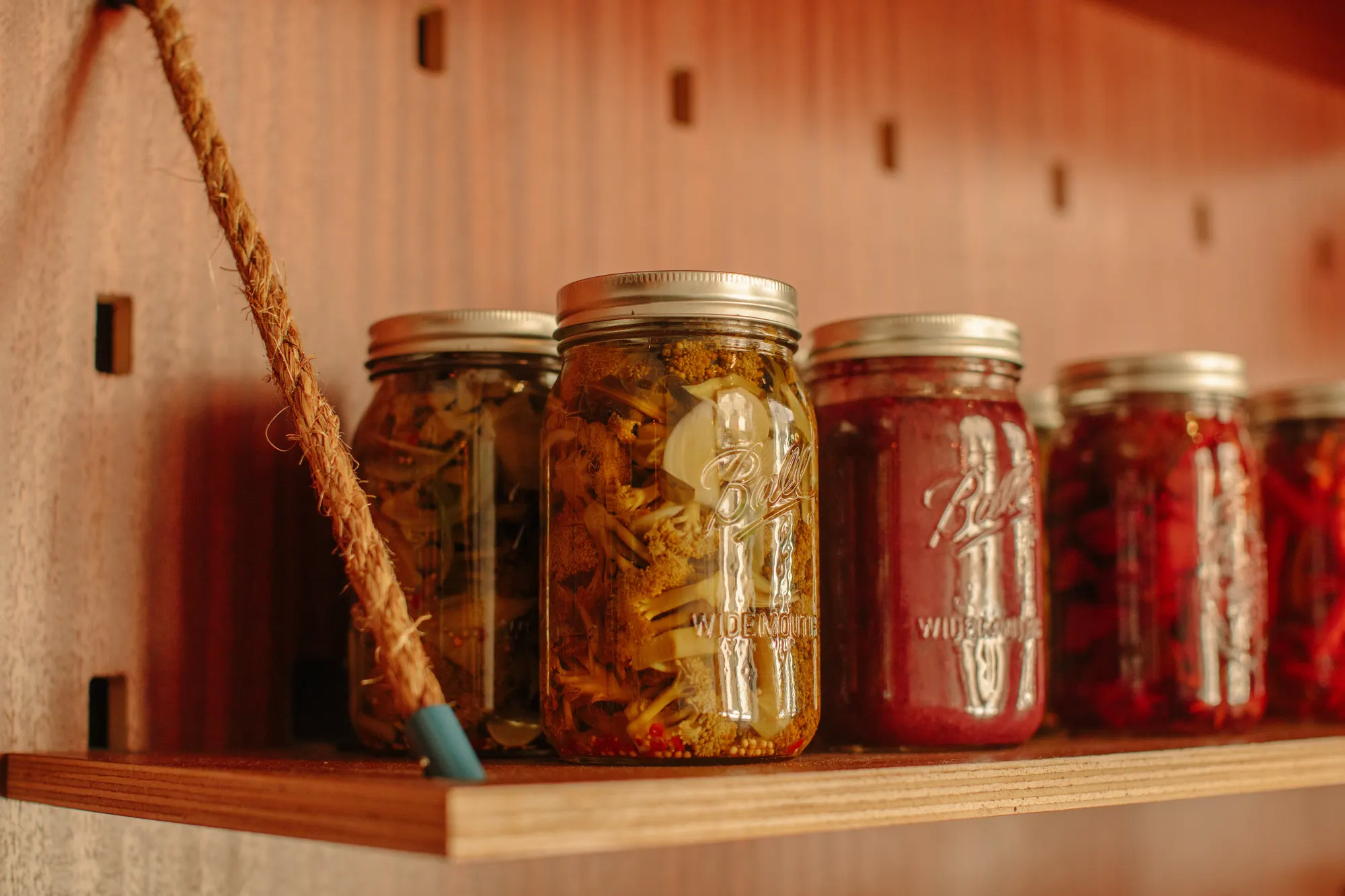 Jars kept at eye level on the open shelf, where they are as much of the room as the lighting is.