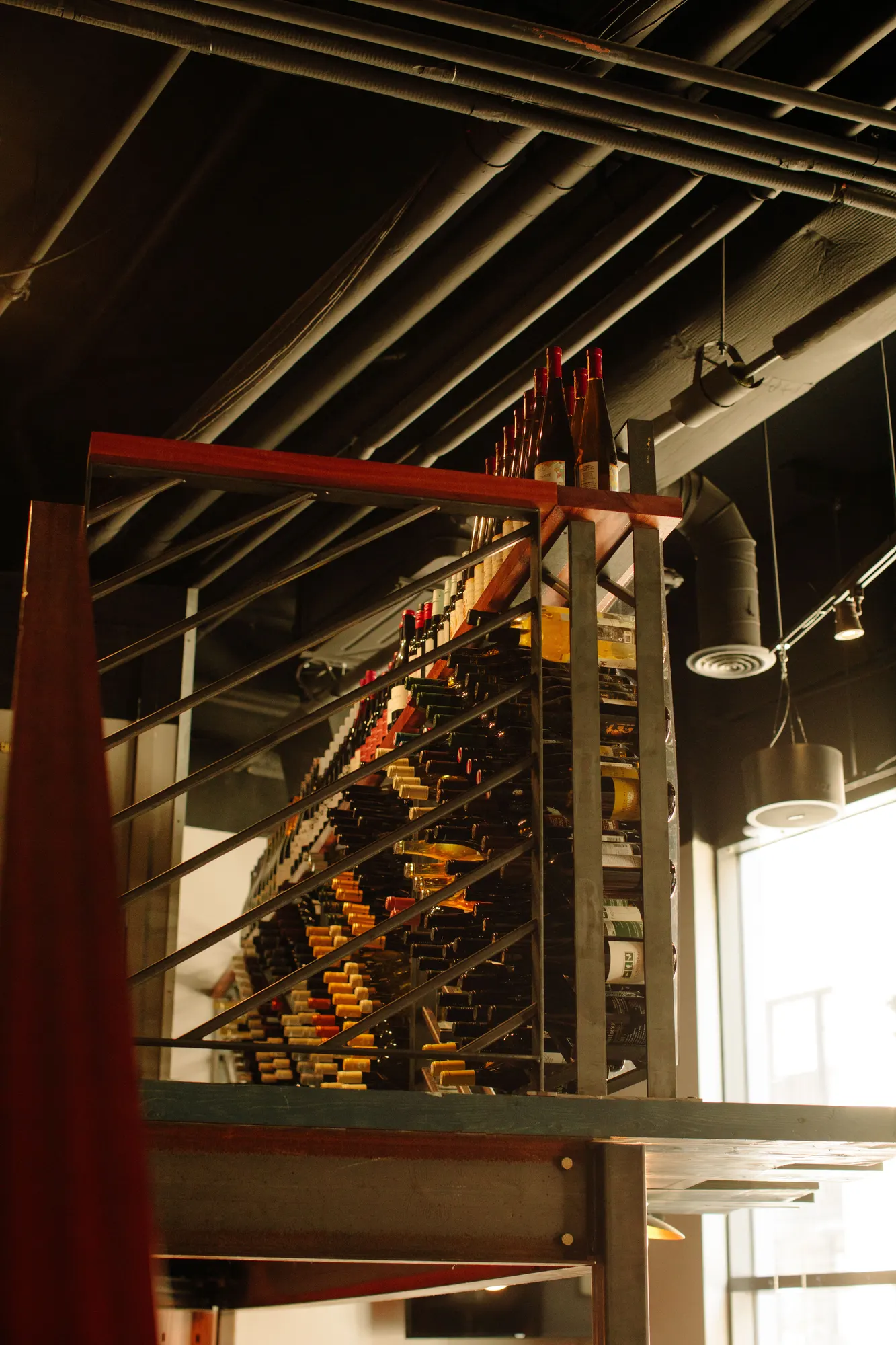 The ceiling is left open — conduit, duct and track all on show above the room.