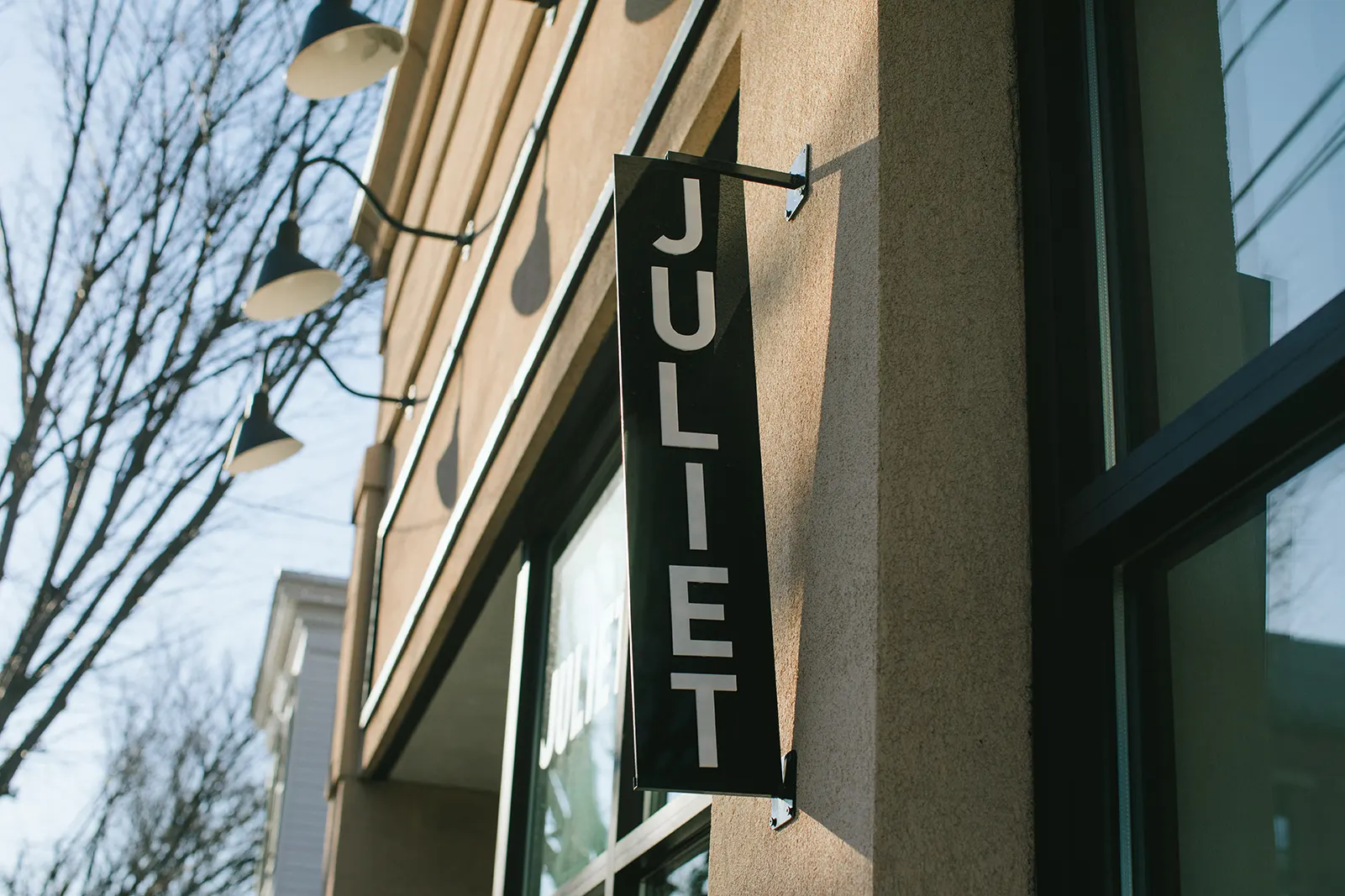 A hanging sign reading Juliet on the front of the building.