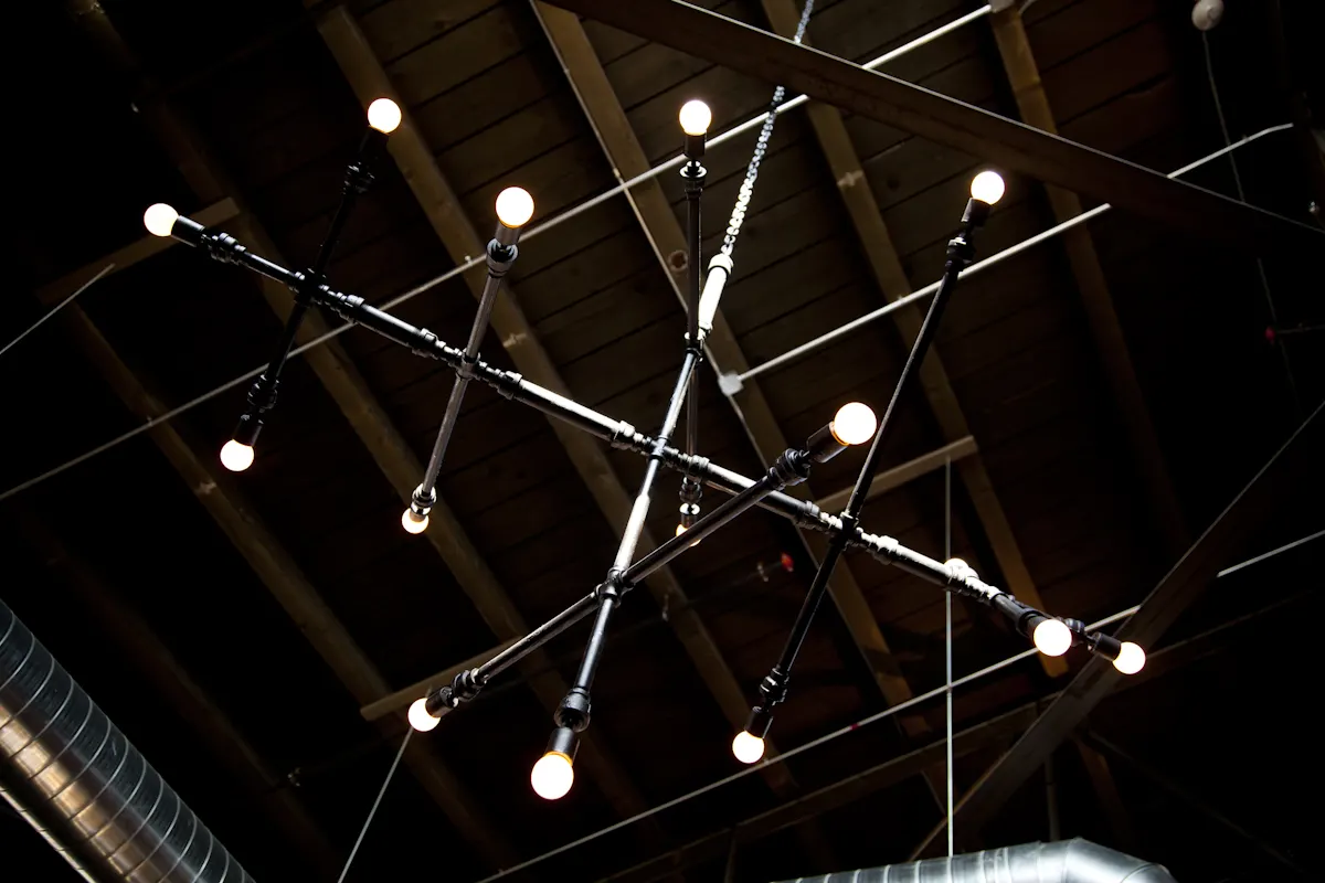 A fitting strung between the rafters, the one piece of ornament overhead.