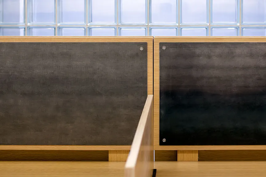 Dark panels in a timber frame, under a band of glass block.