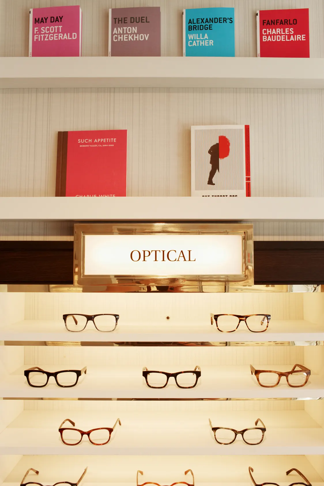 Frames on their own shelf, lit and labelled.