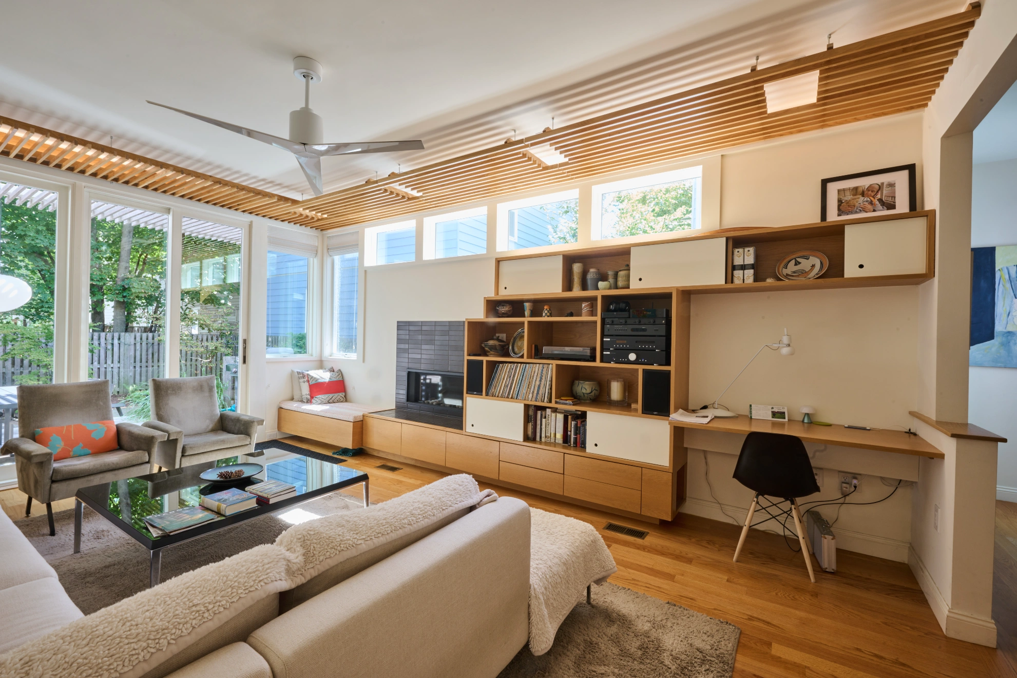 The living room at Pearl Street, maple built-ins under a slatted timber ceiling